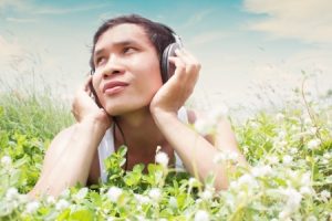 Man Listening to an audiobook is a field